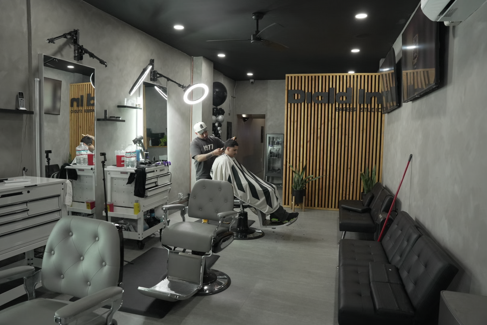 Professional barber studio interior with modern styling chairs and equipment